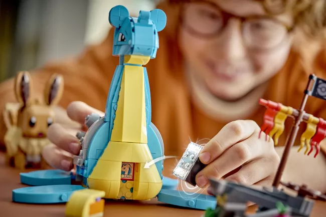 Dítě vkládá chytrou kostku Lego do sestaveného Pokémona.